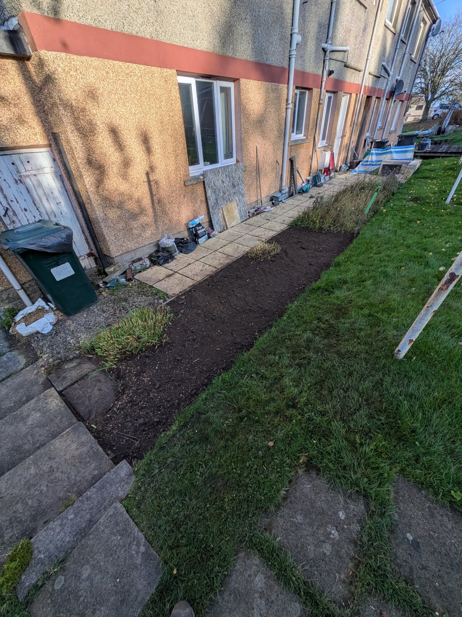 The same border weeded and turned, after